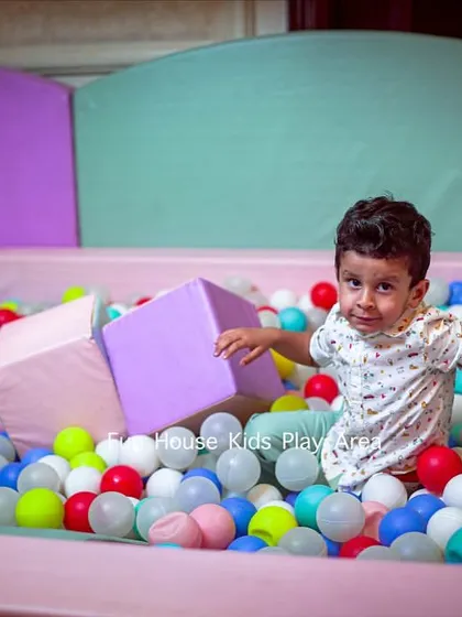 A candid moment of pure fun in our pastel-themed ball pit. We make sure every play area is filled with opportunities for laughter and play, using clean, multi-colored balls for extra excitement.