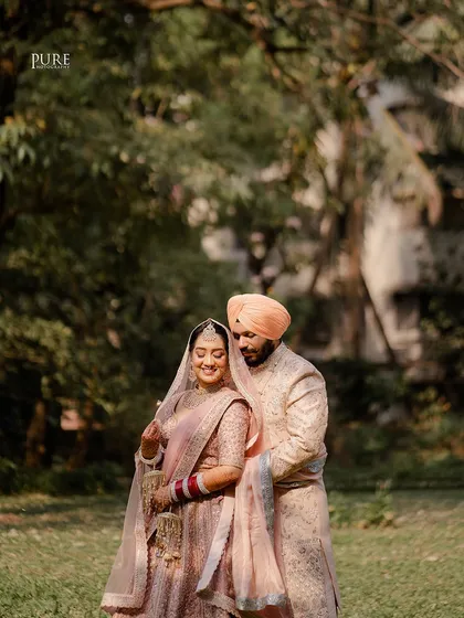 An intimate portrait capturing the couple's gentle embrace. The soft light and natural background highlight their connection and pastel wedding outfits.