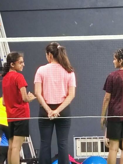 Taking a moment to connect with young athletes on the court. Building trust and understanding their goals is a key part of being an effective coach and physio.