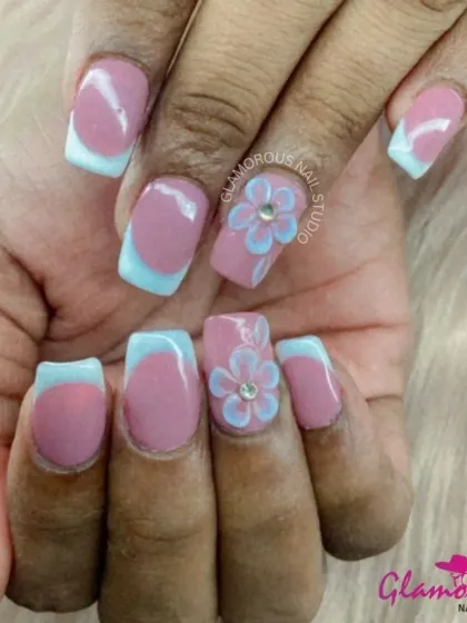 A sweet and playful design. We combined a dusty rose base with baby blue French tips and added a cute, hand-painted 3D flower on the accent nails. This look is perfect for a soft, pastel vibe.