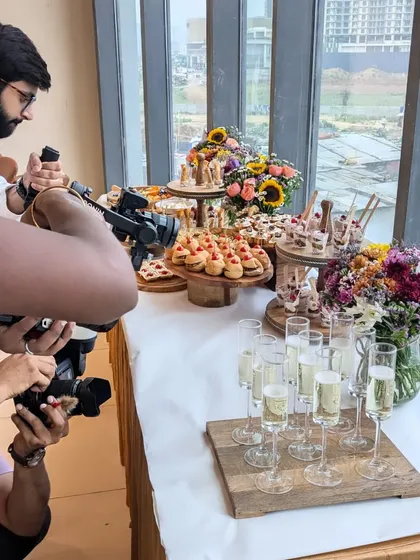 A behind-the-scenes shot of my team capturing the beautiful spread at the Varnya salon launch. We ensure every detail is picture-perfect before the guests arrive.