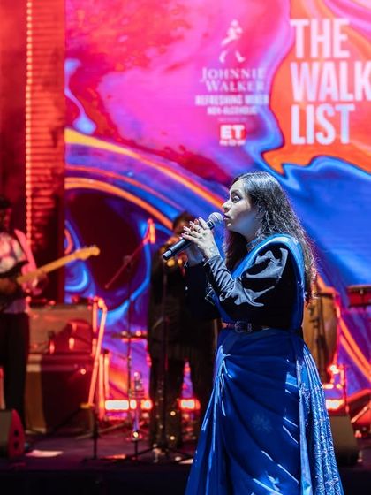 A vibrant moment on stage during 'The Walkers List' event. The colorful backdrop and stage lighting perfectly matched the high-energy fusion music we shared with the audience that evening.