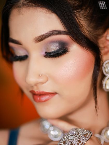 A close-up of the eye makeup, showing a beautiful blend of silver and black eyeshadow.