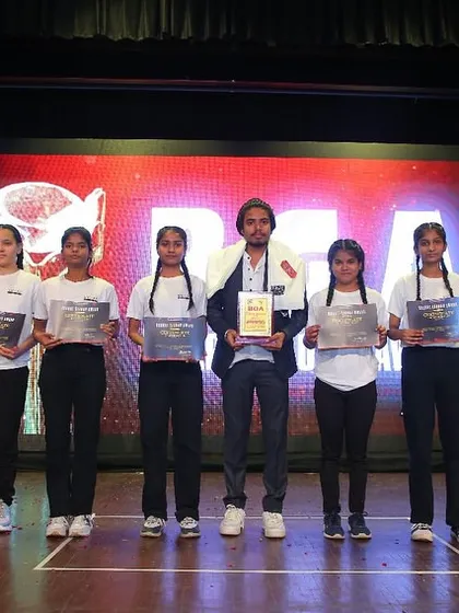 My team and I on stage after receiving an award, a proud moment recognizing our contribution to the art of yoga.