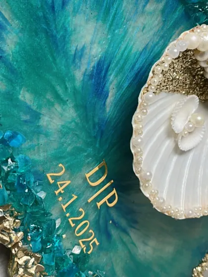 A close-up of the custom initials and the beautiful textures of the seashell ring platter.