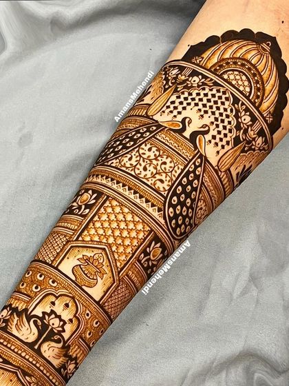 A full arm view showcasing the intricate layers of a traditional design. From the swans at the bottom to the peacocks at the top, every element is beautifully detailed.