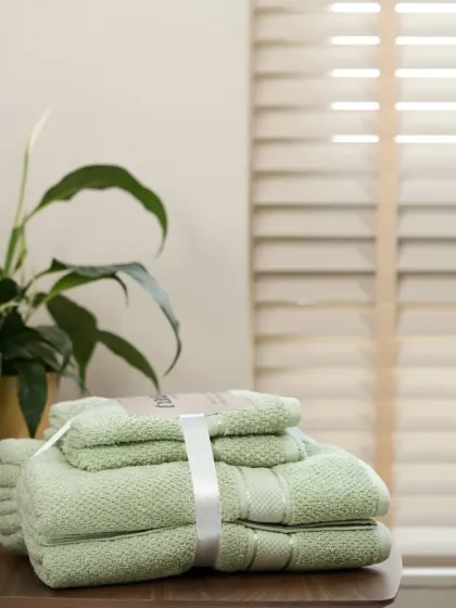 A set of light green towels, maintaining the same composition and lighting. This consistency is crucial for a professional online catalogue.
