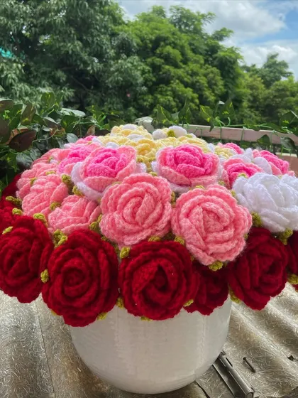 The multi-colored rose bouquet arranged in a vase, a true centerpiece.