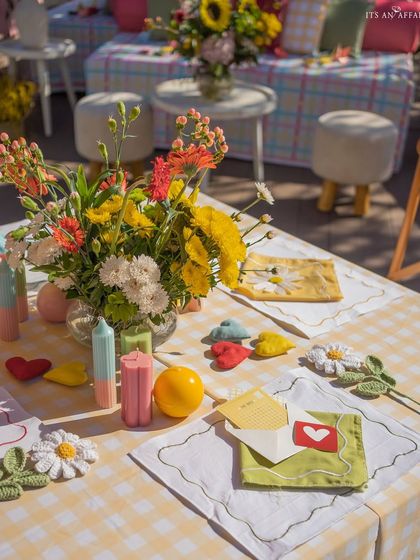 Every detail on the table, from the heart-shaped cushions to the custom stationery, is designed to evoke a feeling of fun and love.