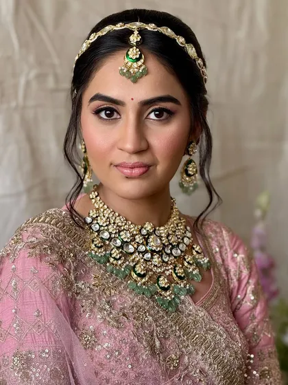 A classic bridal portrait. The makeup is timeless, with a focus on flawless skin and beautifully defined eyes, ensuring she looks perfect from every angle.