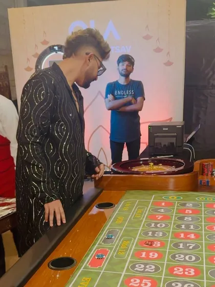 Even the DJ has to try his luck. Having some fun at the casino games set up at the OLA Diwali party.