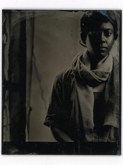 A quiet, contemplative portrait by the window. The way wet plate photography renders light is unlike any other medium, creating soft, painterly tones and deep, rich shadows.