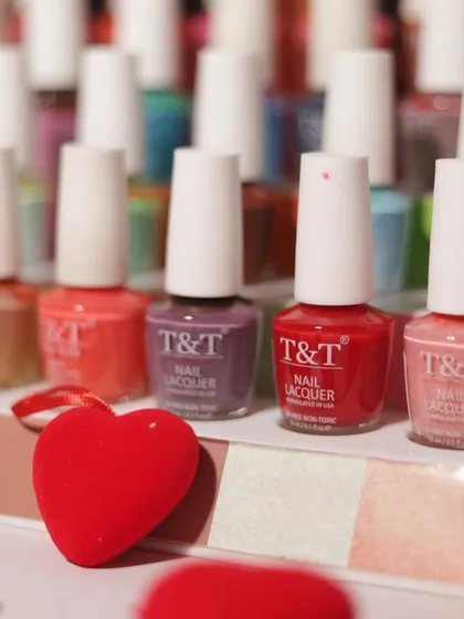 A close-up of our T&T Nail Lacquer collection, surrounded by hearts. Your nails are your canvas, and we have the perfect shades for you to paint your story.