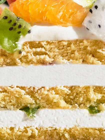 A macro shot of the layers and fruit topping on my Fresh Fruit Gateau. You can see the textures of the sponge, cream, and fresh kiwi and dragon fruit.