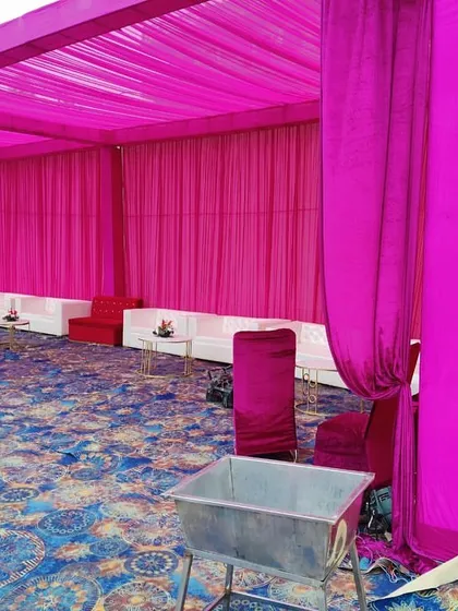 Another view of a tented section, showing the bright pink ceiling and wall drapes. I ensure every part of the venue is decorated according to the chosen color theme.