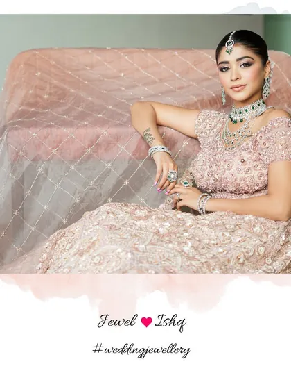 A moment of quiet elegance. The bride looks absolutely regal in her pink lehenga and our full emerald and diamond jewellery suite.