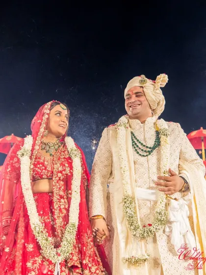 A quiet moment of connection amidst the celebration. The bride and groom share a look of love and happiness, surrounded by the beautiful decor of their wedding ceremony.