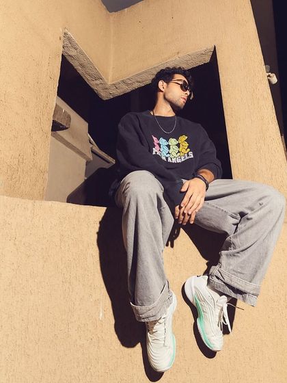 An atmospheric shot from the HT Brunch feature. The same casual outfit on Siddhant Chaturvedi takes on a different mood with dramatic lighting, highlighting the versatility of the styling.