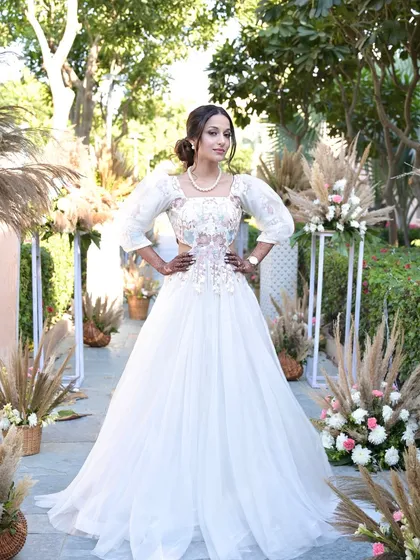 A stunning look for a carnival-themed wedding event. The bride looks like a princess in her white ball gown, with makeup that is soft, romantic, and elegant.