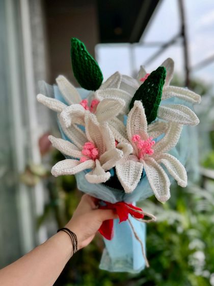 We're so excited to launch our new crochet lilies! This beautiful bouquet features several white lily stems with delicate pink centers, creating a full and elegant look.