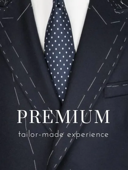 A close-up of a suit jacket being tailored, showing the temporary basting stitches. This is part of the premium, tailor-made experience I promise every client.