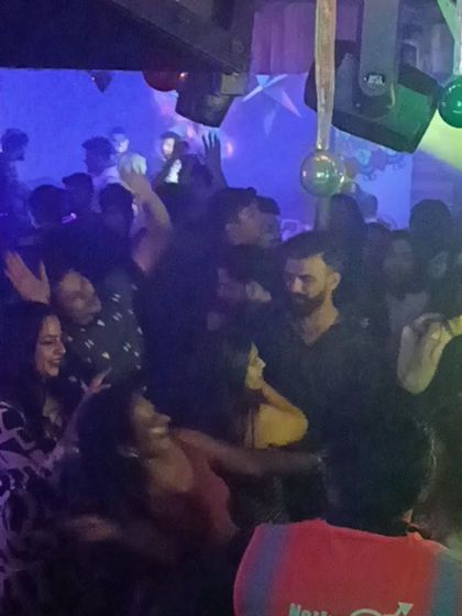 Another shot of the packed floor, with people dancing and smiling.