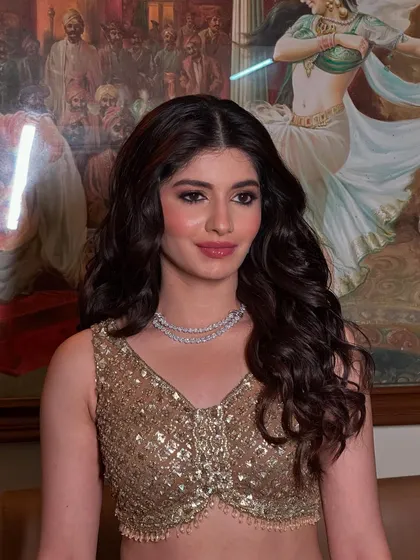 Another angle of this stunning sangeet look, showing how the curls fall beautifully over the shoulders, complementing the intricate diamond necklace.