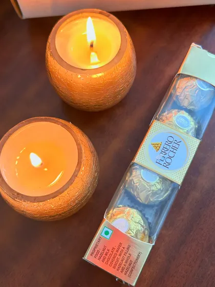 Our mini Diwali hamper in action. The warm glow of the candles and the delicious chocolates make it a delightful gift for your loved ones.