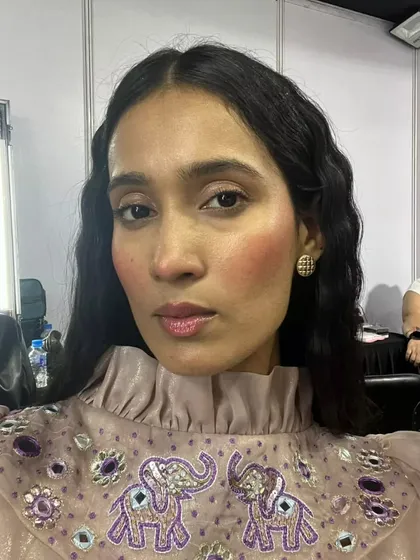 Another angle of the blush draping technique. This look focuses on creating a youthful, healthy glow with glossy lips and dewy skin, perfect for runway or a fresh party look.