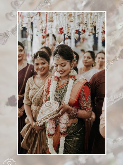 The bride smiling as she participates in a wedding ritual, surrounded by the warm smiles of her family.