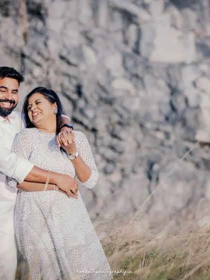 Another candid moment of laughter and affection from the same outdoor maternity session, showing the couple's genuine happiness.