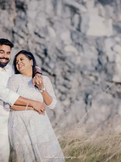 Another candid moment of laughter and affection from the same outdoor maternity session, showing the couple's genuine happiness.
