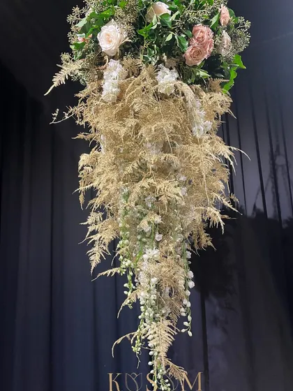 This cascading pastel flower chandelier was designed to create a whimsical and ethereal atmosphere. I used delicate golds, creams, and soft pinks to craft a piece that feels incredibly charming and light.