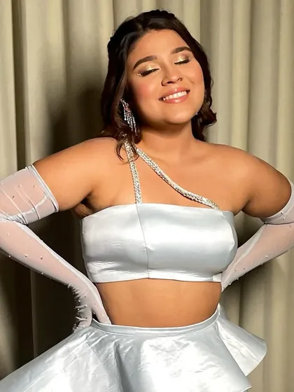 A close-up of Yashi's glowing makeup. The soft shimmer on her eyes and cheeks catches the light beautifully, adding to the magical feel of her look.