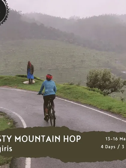 Our 'Misty Mountain Hop' is a 4-day, 3-night tour through the Nilgiris. This image of a rider on a wet, misty road perfectly captures the atmosphere of this unique cycling experience.