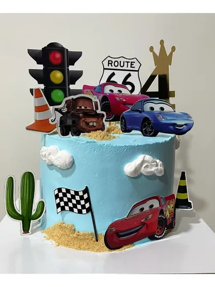 Another take on the "Cars" theme cake, this one featuring more toppers like traffic lights and cacti for a full desert race scene.