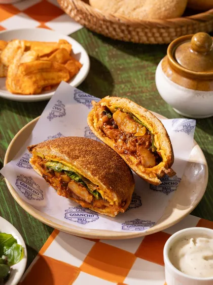 A Goan-style cutlet pav, cut in half to show the delicious filling. A great shot for a cafe menu.