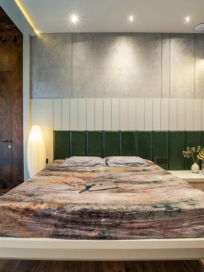 A frontal view of the bed, showing the rich textures and the warm, inviting ambiance created by the lighting.