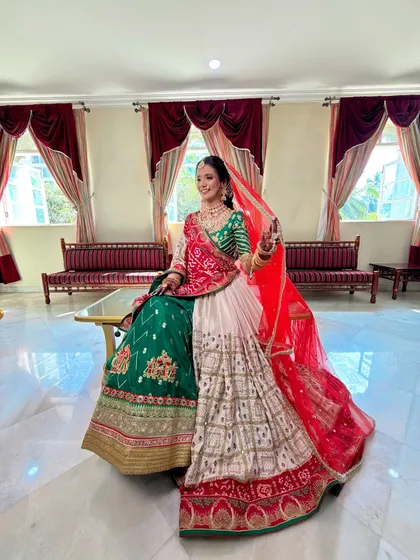 This shot captures the full splendor of the bride's outfit and makeup. The colors are vibrant, and she looks every bit the part of a royal bride.