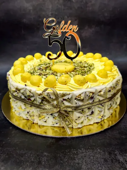 My Royal Rasmalai Cake is one of my bestsellers, perfect for celebrating major milestones like a 50th birthday. I infuse the light sponge with traditional rasmalai flavor and top it with actual rasmalai pieces, pistachios, and delicate gold leaf for a truly luxurious Indian fusion dessert.