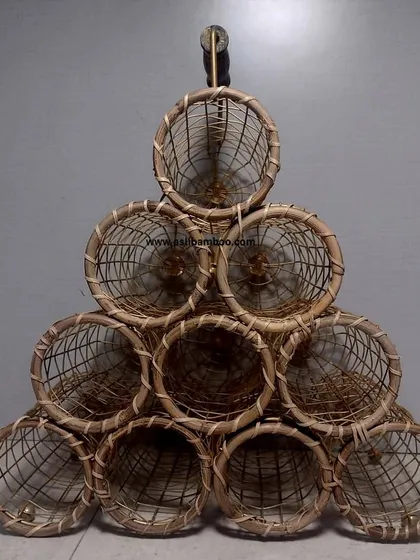 Our handcrafted rattan and cane wine rack, designed to hold ten bottles in a pyramid stack. This unique piece is a stylish and rustic way to store and display your wine collection, perfect for a kitchen counter or bar.
