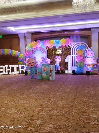 The Cocomelon stage viewed from the side, highlighting the marquee letters and character props.