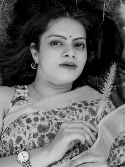 A stunning black and white solo portrait of the bride. Her direct gaze and the soft, natural lighting create a powerful and timeless image that is both elegant and soulful.