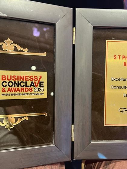 A close-up of the plaque awarded to Senior Partner S.T. Prashantha Kumar at the ET Business Conclave & Awards 2025. The award acknowledges his outstanding contributions to real estate legal consultation.