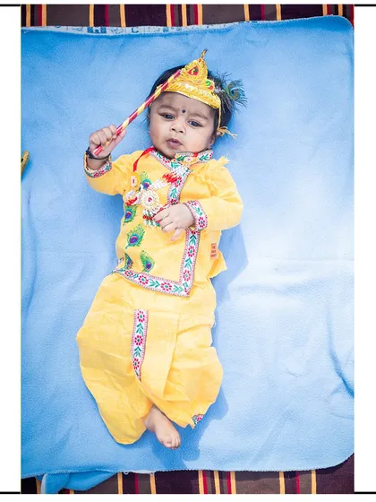 Another shot from a newborn Krishna-themed session, showing the intricate details of the costume and props I provide.