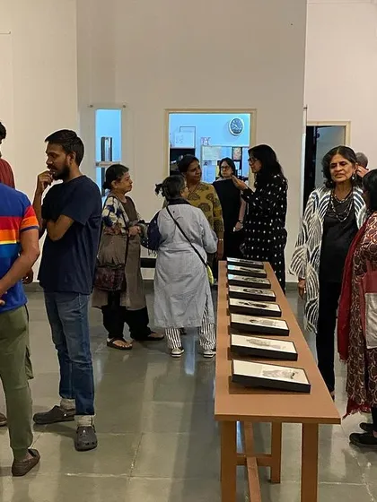 Visitors at the opening night of 'Quieter than Silence', interacting with each other and the art.