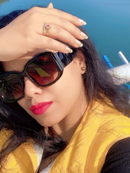 A close-up selfie from a winter trip, with a bright pink lip and oversized sunglasses.