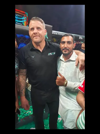 A moment of mutual respect between a guest and a world-class MMA official at an MFN event.