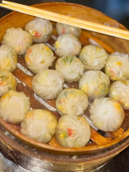 A basket full of my handcrafted dim sums, showcasing the delicate folds and fillings. I offer a variety of options to bring the authentic taste of Asia to your event.