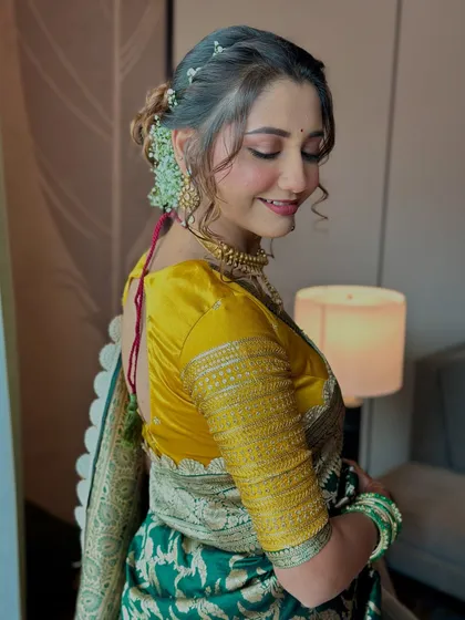 A side profile of this elegant bride. The soft, romantic updo with fresh flowers is the perfect complement to her minimal and classy makeup look.